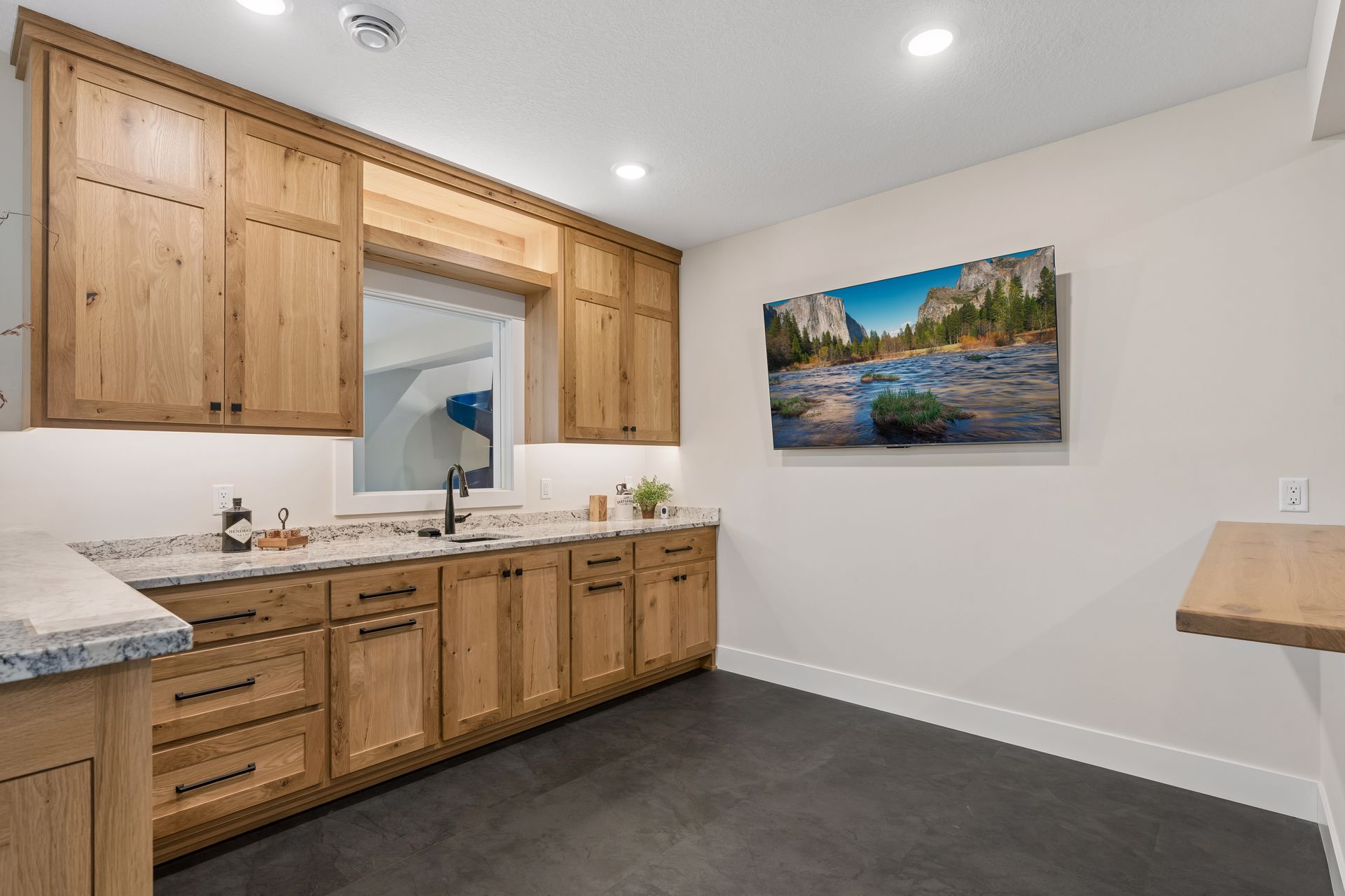 Lower level entertainment area with custom cabinetry, seating and recreation space
